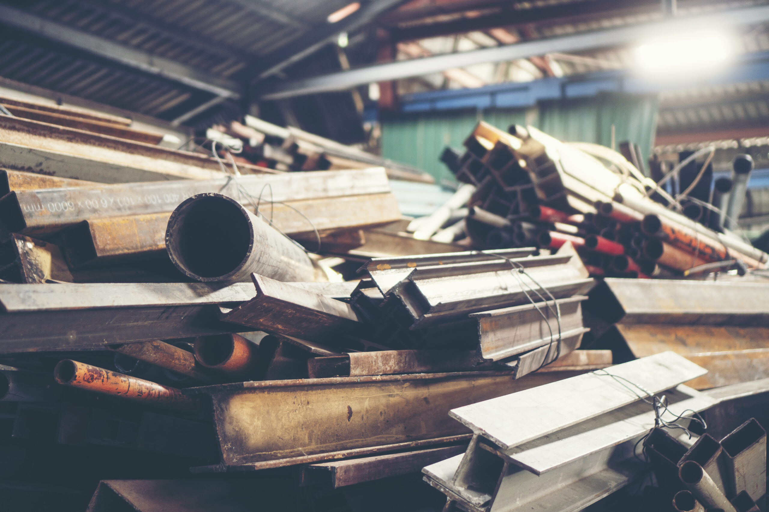 Rows of Steel Round Bar storage and stacking in the warehouse for industrial construction