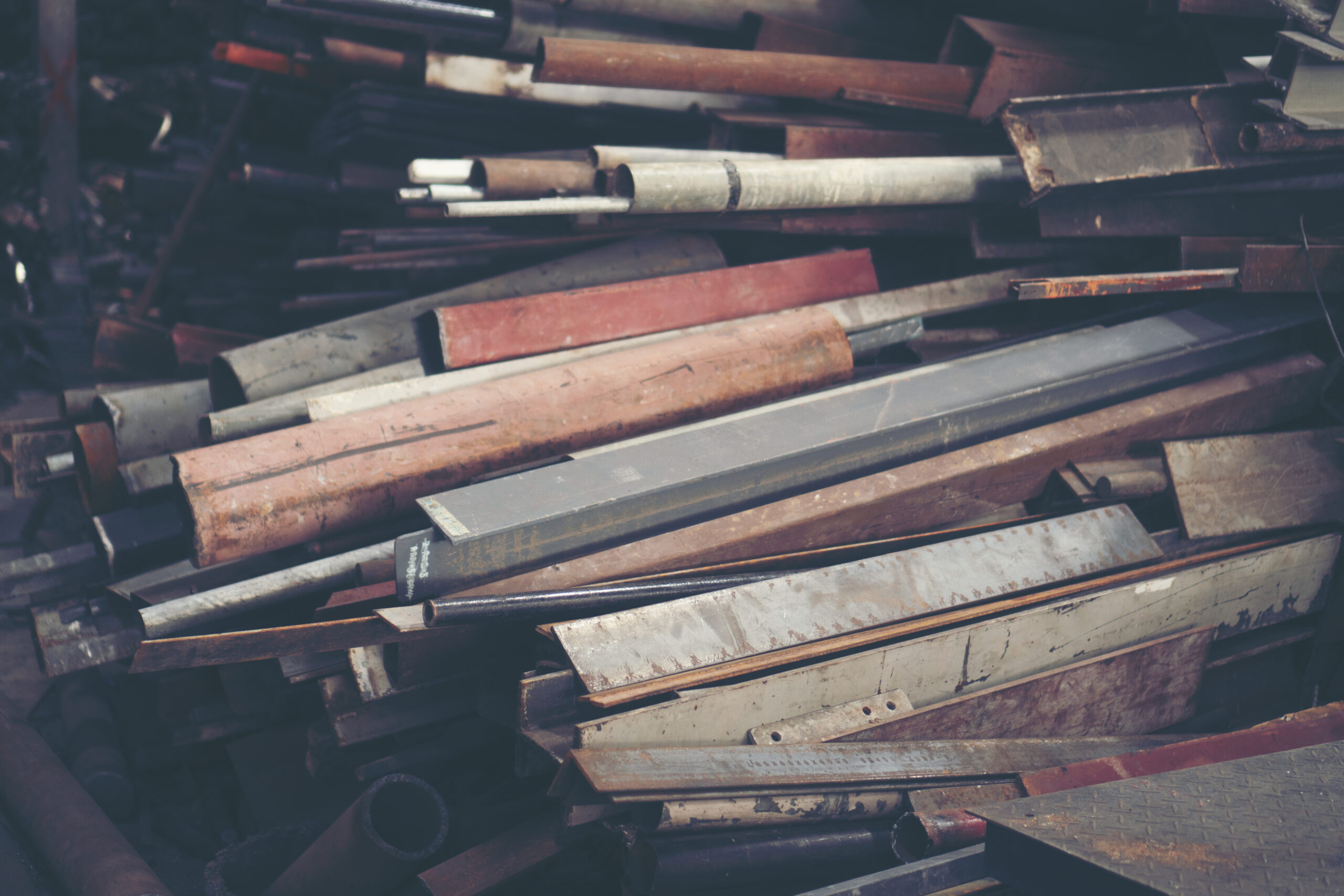 Stack of steel pipes in metal factory shop
